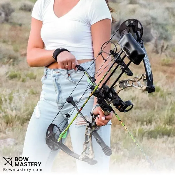 women holding compound bow with all accessories