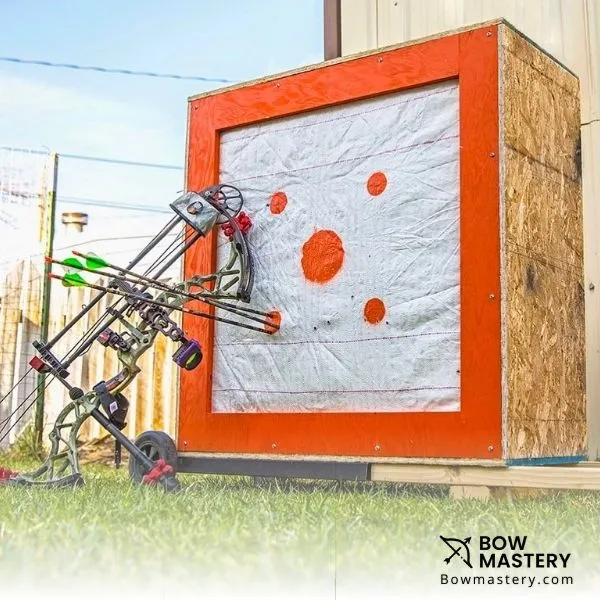 large wooden archery target with bow